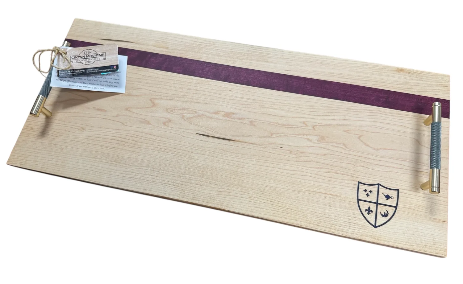 Rectangular wooden tray with metal handles, purple detail, and engraved crest