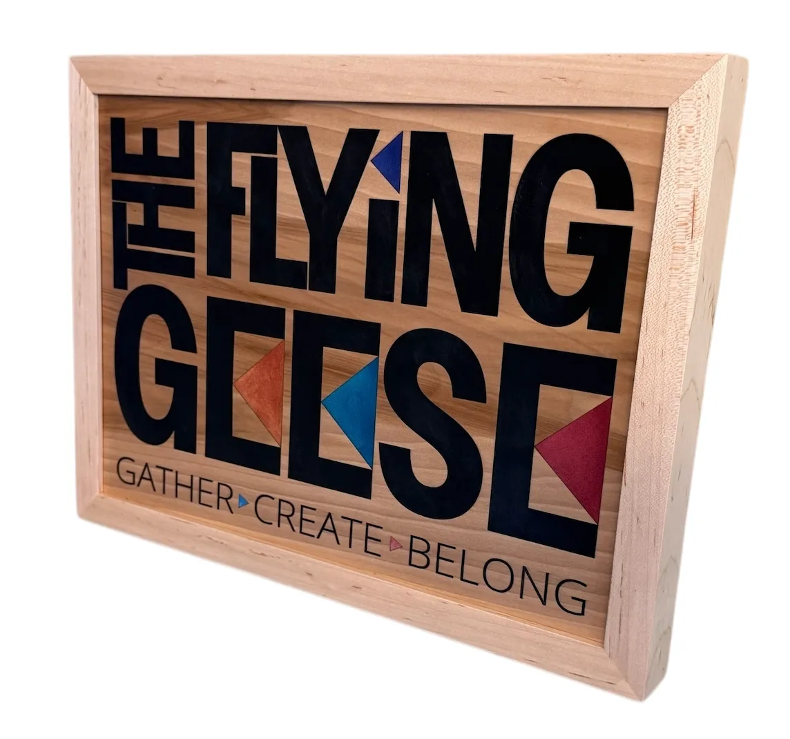 Decorative wooden Flying Geese sign with colorful geometric birds