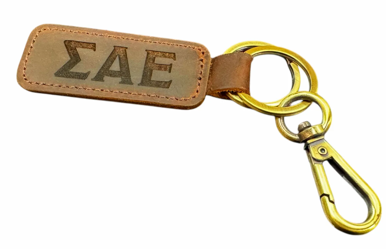 Leather keychain engraved with Greek letters and attached to a metal clip